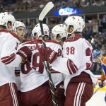 Arizona Coyotes' Connor Murphy (5), Mikkel Boedker (89), Lucas Lessio (38) and teammates celebrate a goal against the Edmonton Oilers during the first period of an NHL hockey preseason game, Wednesday, Oct. 1, 2014, in Edmonton, Alberta. (AP Photo/The Canadian Press, Jason Franson)