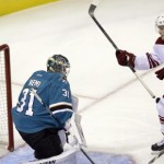 A shot from Arizona Coyotes' Justin Hodgeman, not pictured, gets past San Jose Sharks goalie Antti Niemi (31), of Finland, for a goal as Coyotes' Henrik Samuelsson (15) and Sharks' Justin Braun (61) watch during the first period of an NHL preseason hockey game Friday, Sept. 26, 2014, in San Jose, Calif. (AP Photo/Marcio Jose Sanchez)