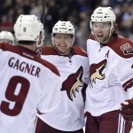 Arizona Coyotes' Martin Hanzal (11) celebrates his goal against the Toronto Maple Leafs with teammates Sam Gagner (9) and Martin Erat (10) during the second period of an NHL hockey game Thursday, Jan. 29, 2015, in Toronto. (AP Photo/The Canadian Press, Frank Gunn)
