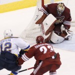 St. Louis Blues' Jori Lehtera (12), of Finland, scores a goal against Arizona Coyotes' Mike Smith, rear, as Coyotes' Oliver Ekman-Larsson (23), of Sweden, defends during the third period of an NHL hockey game Saturday, Oct. 18, 2014, in Glendale, Ariz. The Blues defeated the Coyotes 6-1. (AP Photo/Ross D. Franklin)