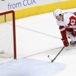 Detroit Red Wings' Darren Helm (43) eyes the puck after scoring an empty net goal against the Arizona Coyotes during the third period of an NHL hockey game Saturday, Feb. 7, 2015, in Glendale, Ariz. The Red Wings defeated the Coyotes 3-1. (AP Photo/Ross D. Franklin)