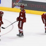Arizona Coyotes' Sam Gagner (9), Keith Yandle (3) and Brandon McMillan (22) skate off the ice after an NHL hockey game against the Calgary Flames on Thursday, Jan. 15, 2015, in Glendale, Ariz. The Flames defeated the Coyotes 4-1. (AP Photo/Ross D. Franklin)