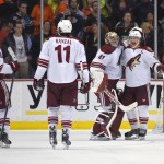 Arizona Coyotes goalie Mike Smith, second from right, celebrates with right wing Shane Doan, right, along with center Antoine Vermette, left, and center Martin Hanzal, of the Czech Republic, after the Coyotes defeated the Anaheim Ducks following the shootout in an NHL hockey game, Friday, Nov. 7, 2014, in Anaheim, Calif. The Coyotes won 3-2. (AP Photo/Mark J. Terrill)