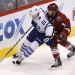 Toronto Maple Leafs left wing James Van Riemsdyk (21) shields Arizona Coyotes defenseman Keith Yandle (3) from the puck during the third period during an NHL hockey game, Tuesday, Nov. 4, 2014, in Glendale, Ariz. The Coyotes won 3-2. (AP Photo/Rick Scuteri)