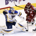 St. Louis Blues' Brian Elliott, left, makes a save on a shot as Arizona Coyotes' Lauri Korpikoski (28), of Finland, moves in for a possible rebound as Blues' Chris Butler, right, defends during the second period of an NHL hockey game Tuesday, Jan. 6, 2015, in Glendale, Ariz. (AP Photo/Ross D. Franklin)