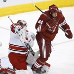 Carolina Hurricanes' Cam Ward, left, deflects the puck as Arizona Coyotes' B.J. Crombeen (44) tries to screen Ward during the first period of an NHL hockey game Thursday, Feb. 5, 2015, in Glendale, Ariz. (AP Photo/Ross D. Franklin)