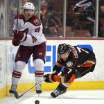 Arizona Coyotes left wing Mikkel Boedker, left, of Denmark, passes the puck as Anaheim Ducks center Andrew Cogliano watches during the second period of an NHL hockey game, Friday, Nov. 7, 2014, in Anaheim, Calif. (AP Photo/Mark J. Terrill)