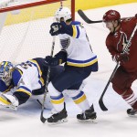 St. Louis Blues' Jake Allen (34) makes a diving save on a shot as Blues' Kevin Shattenkirk (22) and Arizona Coyotes' Shane Doan, right, both look on during the second period of an NHL hockey game Saturday, Oct. 18, 2014, in Glendale, Ariz. (AP Photo/Ross D. Franklin)