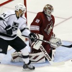 Arizona Coyotes goalie Devan Dubnyk (40) makes the save in front of Los Angeles Kings left wing Dwight King (74) in the third period during an NHL hockey game, Thursday, Dec. 4, 2014, in Glendale, Ariz. (AP Photo/Rick Scuteri)