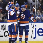 New York Islanders right wing Colin McDonald (13) center Brock Nelson (29) and left wing Josh Bailey (12) celebrate Nelson's goal in the third period of an NHL hockey game against the Arizona Coyotes, Tuesday, Feb. 24, 2015, in Uniondale, N.Y. The Islanders won 5-1. (AP Photo/Kathy Kmonicek)