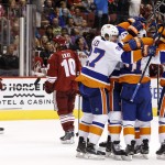 New York Islanders' Anders Lee (27) and Nick Leddy (2) celebrate a goal by teammate Frans Nielsen, second from right, as Arizona Coyotes' Brandon McMillan (22) and Martin Erat (10), of the Czech Republic, skate away during the third period of an NHL hockey game Saturday, Nov. 8, 2014, in Glendale, Ariz. The Islanders defeated the Coyotes 1-0. (AP Photo/Ross D. Franklin)
