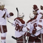 Arizona Coyotes defenseman David Schlemko is greeted by teammates from left, Antoine Vermette, Lauri Korpikoski, Mikkel Boedker, and Michael Stone after scoring a goal during the first period of an NHL hockey game against the San Jose Sharks Saturday, Nov. 22, 2014, in San Jose, Calif. (AP Photo/Eric Risberg)