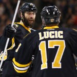 Boston Bruins' Zdeno Chara is congratulated by teammate Milan Lucic (17) after scoring against the Arizona Coyotes during the second period of an NHL hockey game in Boston Saturday, Feb. 28, 2015. (AP Photo/Winslow Townson)