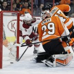Arizona Coyotes' Sam Gagner (9), left, makes sure the puck hit by Connor Murphy , not pictured, goes in the net behind Philadelphia Flyers goalie Ray Emery (29) in the first period of an NHL hockey game, Tuesday, Jan. 27, 2015, in Philadelphia. (AP Photo/Tom Mihalek)