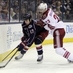 Arizona Coyotes' Oliver Ekman-Larsson, right, of Sweden, checks Columbus Blue Jackets' Brandon Dubinsky during the second period of an NHL hockey game Tuesday, Feb. 3, 2015, in Columbus, Ohio. (AP Photo/Jay LaPrete)
