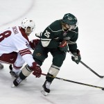Arizona Coyotes left wing Lauri Korpikoski (28), of Finland, reaches for the puck controlled by Minnesota Wild defenseman Jonas Brodin (25) during the first period of an NHL hockey game Saturday, Jan. 17, 2015, in St. Paul, Minn. (AP Photo/Hannah Foslien)
