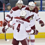 Arizona Coyotes' Oliver Ekman-Larsson (23), Tobias Rieder (8) and Zbynek Michalek (4) celebrate a goal against the Edmonton Oilers during the second period of an NHL hockey game in Edmonton, Alberta., on Monday, Dec. 1, 2014. (AP Photo/The Canadian Press, Jason Franson)