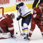Arizona Coyotes' Mike Smith (41) makes a save on a shot by St. Louis Blues' T.J. Oshie, middle, as Coyotes' Oliver Ekman-Larsson (23), of Sweden, defends during the first period of an NHL hockey game Saturday, Oct. 18, 2014, in Glendale, Ariz. (AP Photo/Ross D. Franklin)