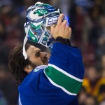 Vancouver Canucks goalie Ryan Miller puts on his mask before an NHL hockey game against the Arizona Coyotes in Vancouver, British Columbia, Monday, Dec. 22, 2014. (AP Photo/The Canadian Press, Darryl Dyck)