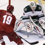 Minnesota Wild's Ilya Bryzgalov, right, of Russia, makes a save on a shot by Phoenix Coyotes' Shane Doan (19) during the third period of an NHL hockey game, Saturday, March 29, 2014, in Glendale, Ariz. The Wild defeated the Coyotes 3-1. (AP Photo/Ross D. Franklin)