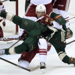 Arizona Coyotes defenseman Connor Murphy (5) and Minnesota Wild left wing Zach Parise (11) get tied up during the third period of an NHL hockey game Saturday, Jan. 17, 2015, in St. Paul, Minn. No penalties were called on the play. The Wild won 3-1. (AP Photo/Hannah Foslien)
