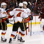 Calgary Flames' Mikael Backlund, right front, of Sweden, celebrates his goal against Arizona Coyotes' Mike Smith, right, with teammates Kris Russell (4); Jiri Hudler (24), of the Czech Republic; and Johnny Gaudreau, left, during the second period of an NHL hockey game Thursday, Jan. 15, 2015, in Glendale, Ariz. (AP Photo/Ross D. Franklin)