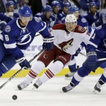 Tampa Bay Lightning defenseman Anton Stralman (6), of Sweden, caries the puck around Arizona Coyotes left wing Rob Klinkhammer (36) and Lightning center Valtteri Filppula (51), of Finland, during the first period of an NHL hockey game Tuesday, Oct. 28, 2014, in Tampa, Fla. (AP Photo/Chris O'Meara)