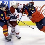  Florida Panthers center Vincent Trocheck (67) and defenseman Tom Gilbert (77) battle against Phoenix Coyotes right wing Radim Vrbata (17) of the Czech Republic, during the first period of an NHL hockey game, Tuesday, March 11, 2014, in Sunrise, Fla. (AP Photo/Wilfredo Lee)