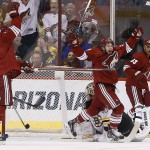  Phoenix Coyotes' Shane Doan, second from left, celebrates his goal against Boston Bruins' Tuukka Rask, bottom right, of Finland, as Coyotes' Brandon McMillan, third from left, and Mike Ribeiro (63) join the celebration as Bruins' Chris Kelly (23) looks on during the first period of an NHL hockey game on Saturday, March 22, 2014, in Glendale, Ariz. (AP Photo/Ross D. Franklin)