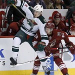 Phoenix Coyotes' Oliver Ekman-Larsson (23), of Sweden, checks Minnesota Wild's Charlie Coyle (3) during the first period of an NHL hockey game, Saturday, March 29, 2014, in Glendale, Ariz. (AP Photo/Ross D. Franklin)