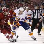 New York Islanders' Nikolai Kulemin (86) deflects the puck off of Arizona Coyotes' Keith Yandle (3) during the third period of an NHL hockey game Saturday, Nov. 8, 2014, in Glendale, Ariz. The Islanders defeated the Coyotes 1-0. (AP Photo/Ross D. Franklin)