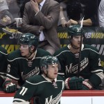 Minnesota Wild coach Mike Yeo stands behind players on the bench during the third period of the Wild's NHL hockey game against the Arizona Coyotes on Saturday, Jan. 17, 2015, in St. Paul, Minn. The Wild won 3-1. (AP Photo/Hannah Foslien)
