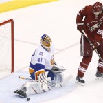 New York Islanders' Jaroslav Halak (41) makes a save on a redirected shot by Arizona Coyotes' Martin Hanzal (11), of the Czech Republic, during the second period of an NHL hockey game Saturday, Nov. 8, 2014, in Glendale, Ariz. The Islanders defeated Coyotes 1-0. (AP Photo/Ross D. Franklin)