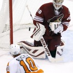 Arizona Coyotes' Devan Dubnyk (40) makes a save on a shot by Philadelphia Flyers' Brayden Schenn (10) during the first period of an NHL hockey game Monday, Dec. 29, 2014, in Glendale, Ariz. (AP Photo/Ross D. Franklin)
