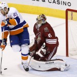 New York Islanders' Kyle Okposo (21) tries to redirect the puck in front of Arizona Coyotes' Mike Smith (41) during the second period of an NHL hockey game Saturday, Nov. 8, 2014, in Glendale, Ariz. The Islanders defeated Coyotes 1-0. (AP Photo/Ross D. Franklin)