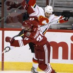 Calgary Flames' Deryk Engelland (29) collides with Arizona Coyotes' Philip Samuelsson (25) during the first period of an NHL hockey game Thursday, Jan. 15, 2015, in Glendale, Ariz. (AP Photo/Ross D. Franklin)