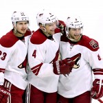 Arizona Coyotes' Zbynek Michalek (4) celebrates with teammates Tobias Rieder (8) and Oliver Ekman-Larsson (23) after scoring against the Ottawa Senators during the first period of an NHL hockey game in Ottawa, Ontario, Saturday, Jan. 31, 2015. (AP Photo/The Canadian Press, Fred Chartrand)
