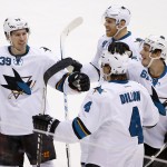 San Jose Sharks' Brenden Dillon (4) celebrates his goal against the Arizona Coyotes with teammates Logan Couture (39), Joe Pavelski (8) and Justin Braun (61) during the third period of an NHL hockey game Tuesday, Jan. 13, 2015, in Glendale, Ariz. The Sharks defeated the Coyotes 3-2. (AP Photo/Ross D. Franklin)
