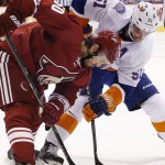 Arizona Coyotes' Antoine Vermette (50) battles New York Islanders' Frans Nielsen (51) for the puck during the first period of an NHL hockey game Saturday, Nov. 8, 2014, in Glendale, Ariz. (AP Photo/Ross D. Franklin)