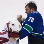 Vancouver Canucks' Tom Sestito, right, and Arizona Coyotes' Kyle Chipchura fight during the second period of an NHL hockey game in Vancouver, British Columbia, Monday, Dec. 22, 2014. (AP Photo/The Canadian Press, Darryl Dyck)