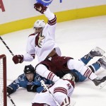 San Jose Sharks' Tomas Hertl, bottom, of the Czech Republic, collides with Arizona Coyotes' Lucas Lessio during the second period of an NHL preseason hockey game Friday, Sept. 26, 2014, in San Jose, Calif. (AP Photo/Marcio Jose Sanchez)