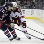 Arizona Coyotes' Kyle Chipchura, right, carries the puck up ice as Columbus Blue Jackets' Ryan Murray defends during the third period of an NHL hockey game Tuesday, Feb. 3, 2015, in Columbus, Ohio. The Coyotes won 4-1. (AP Photo/Jay LaPrete)
