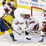 Arizona Coyotes goalie Devan Dubnyk (40) blocks a shot by Nashville Predators center Olli Jokinen (13), of Finland, in the first period of an NHL hockey game Tuesday, Oct. 21, 2014, in Nashville, Tenn. Also defending for the Coyotes are David Schlemko (6) and Kyle Chipchura (24). (AP Photo/Mark Humphrey)