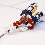 Florida Panthers' Roberto Luongo dives for the puck to make a save against the Arizona Coyotes during the first period of an NHL hockey game Saturday, Oct. 25, 2014, in Glendale, Ariz. (AP Photo/Ross D. Franklin)