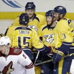 Nashville Predators defenseman Ryan Ellis, second from right, celebrates with Craig Smith (15), Colin Wilson (33) and Seth Jones (3) after Ellis scored against the Arizona Coyotes in the second period of an NHL hockey game Tuesday, Oct. 21, 2014, in Nashville, Tenn. At lower left is Coyotes defenseman Connor Murphy (5). (AP Photo/Mark Humphrey)