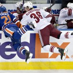 Arizona Coyotes Rob Klinkhammer (36) and Edmonton Oilers Andrew Ference (21) collide during first period NHL hockey action in Edmonton, Alberta, on Sunday, Nov. 16, 2014. (AP Photo/The Canadian Press, Jason Franson)