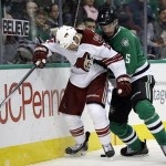 Arizona Coyotes' Kyle Chipchura (24) and Dallas Stars' Jamie Oleksiak (5) compete for control of a puck up in the second period of an NHL hockey game, Thursday, Nov. 20, 2014, in Dallas. (AP Photo/Tony Gutierrez)