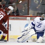 Tampa Bay Lightning goalie Ben Bishop (30) looks up in frustration after giving up a goal to Arizona Coyotes' Michael Stone as Coyotes' Antoine Vermette (50) and Lightning's Victor Hedman both look on during the first period of an NHL hockey game Saturday, Feb. 21, 2015, in Glendale, Ariz. (AP Photo/Ross D. Franklin)