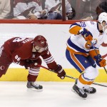 New York Islanders' Brock Nelson (29) tries to keep the puck away from Arizona Coyotes' Mikkel Boedker (89), of Denmark, during the second period of an NHL hockey game Saturday, Nov. 8, 2014, in Glendale, Ariz. The Islanders defeated Coyotes 1-0. (AP Photo/Ross D. Franklin)