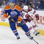Arizona Coyotes' Tobias Rieder (8) chases Edmonton Oilers' Darnell Nurse (74) during the first period of an NHL hockey preseason game, Wednesday, Oct. 1, 2014, in Edmonton, Alberta. (AP Photo/The Canadian Press, Jason Franson)